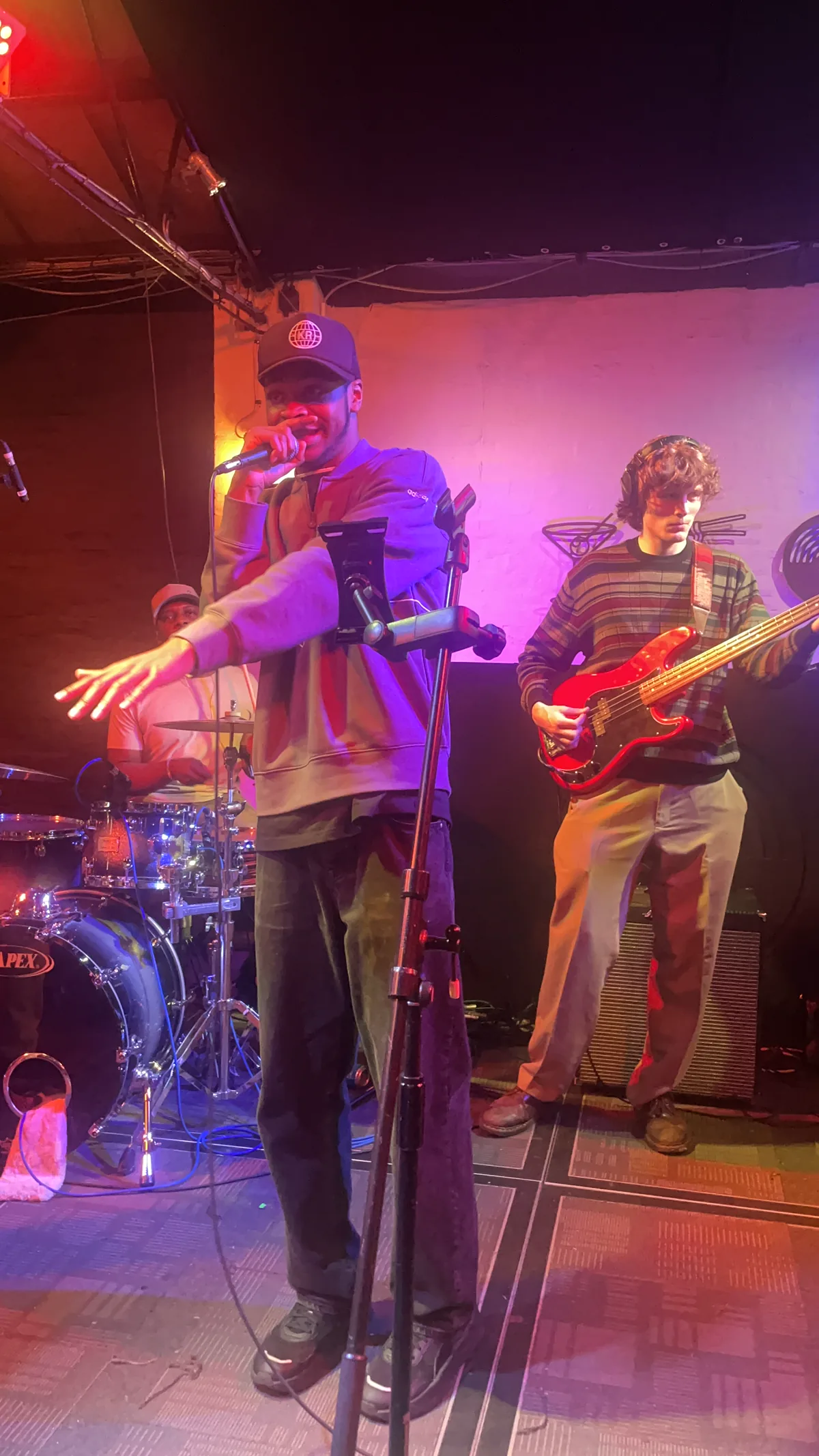 Jesse Ayo performing on stage with a live band